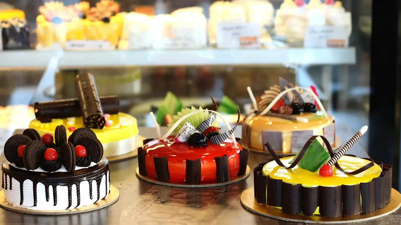A customer happily cutting into a Sugar Honey celebration cake.